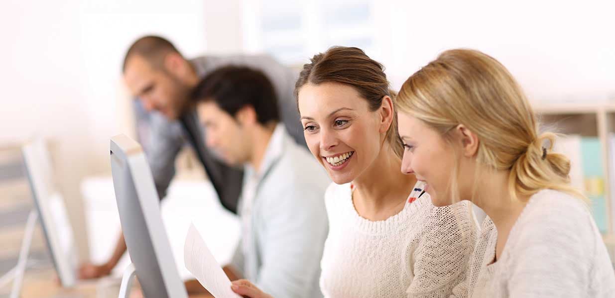 Colleagues learning together at a computer