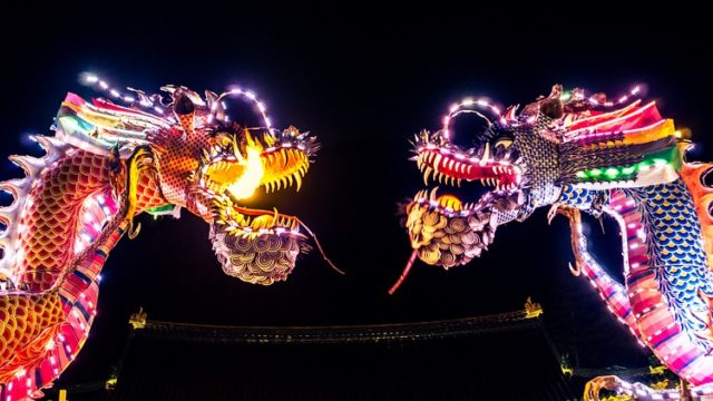 2 brightly lit chinese dragons